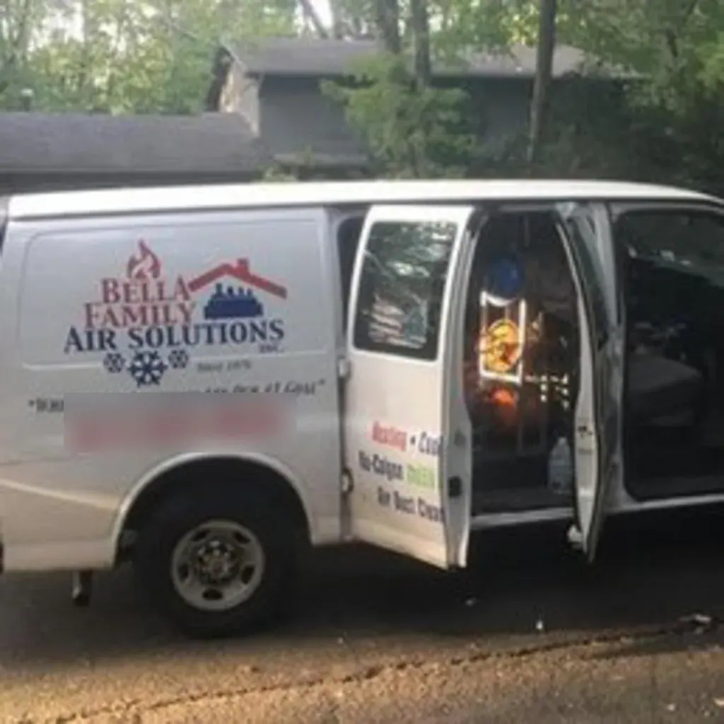 Bella Family Air Solutions service van, lettered “Since 1976,” parked on a residential street in Westchester County, NY